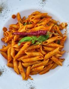 Delicious penne pasta with a spicy tomato sauce made during a cooking vacation in Tuscany with The International Kitchen.