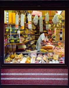 Visiting the local shop for authentic Italian cuisine on a Roman food tour.