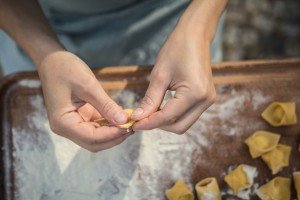 Preparing stuffed pasta in Italy on a culinary tour