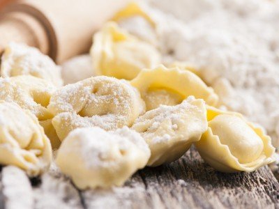 Making tortellini pasta during cooking classes in Italy