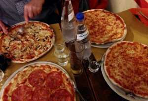 Enjoying pizza at a pizzeria in Rome's Trastevere neighbordhood.