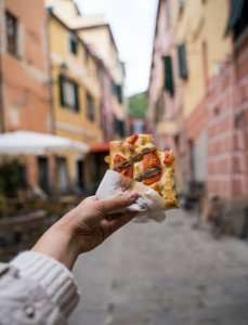 Enjoying pizza rustica, or pizza al taglio, on our culinary vacations in Rome.