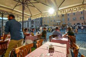 Sitting at an outdoor cafe on pizza Navona in Rome.