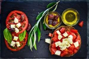 A delicious dish of Greek dakos, made with a Greek barley flour bread and plenty of fresh tomato.