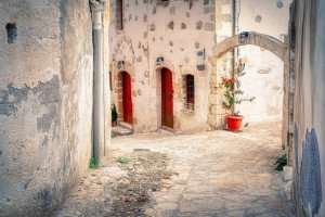 A characteristic alley on the island of Crete, explored during our Greece culinary vacations.