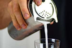 Bartender pouring a craft cocktail.