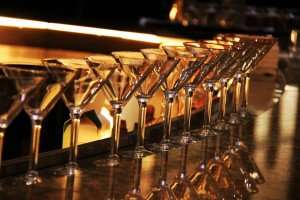 Martini glasses lined up on the bar.