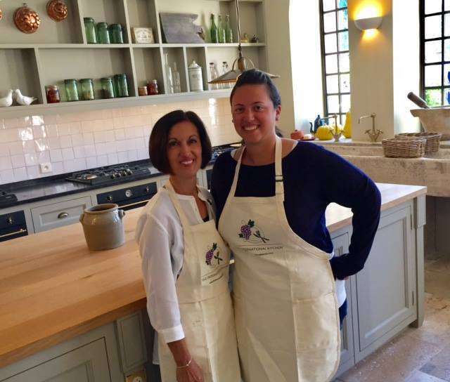Posing before a hands-on cooking class featuring authentic French cuisine.