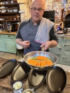 Chef David making glazed carrots with his culinary students.
