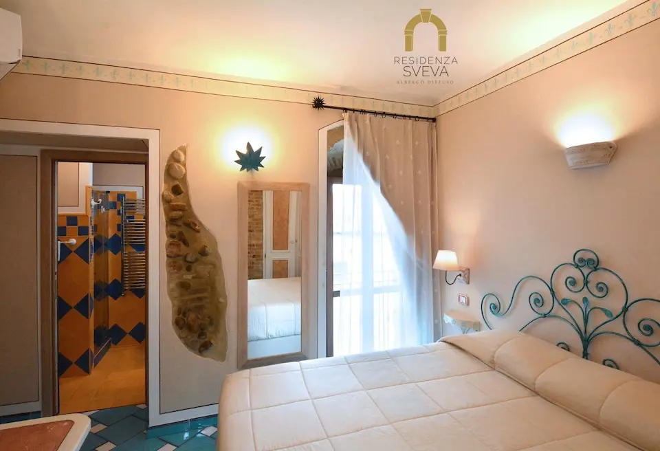 Image for A view of the room and bath at the Residenza Sveva in Termoli, one of the B&Bs that form the Albergo Difuso of the town.