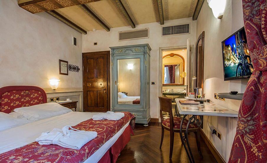 Image for Bedroom at Hotel Commercianti in Bologna, home during your cooking vacation in Italy