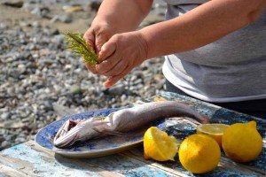 Preparing fish during your Greek Islands culinary tour
