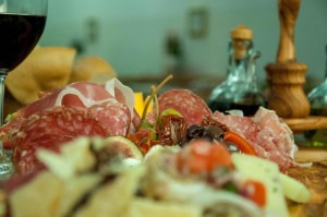 Antipasti and a glass of wine on an Italy cooking vacation with The International Kitchen.