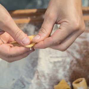 Chef preparing handmade pasta on a culinary vacation in Italy