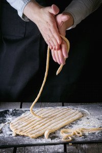 Hand rolling fresh pici pasta as learned on a Tuscany cooking vacation