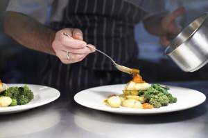 Chef preparing dish in kitchen