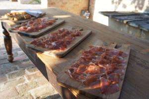 A delicious board of DOP prosciutto on an Italy food tour and cooking vacation in Italy.