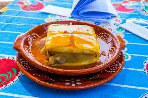 A traditional Francesinha sandwich enjoyed on a Porto food tour.