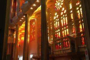 Interior stained glass windows of la Sagrada Familia at sunset.