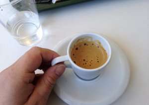 Drinking a fresh cup of espresso.