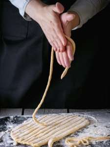 Hand rolling pasta on an authentic culinary vacation in Italy.