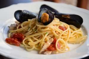 Pasta with mussels on an authentic culinary vacation in Italy.