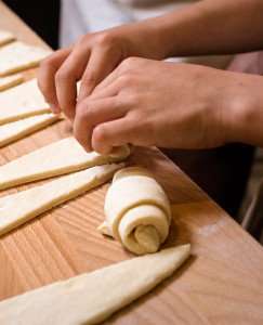 Rolling croissants during a Paris pastry making class.