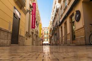 Strolling through the center of Malaga on a gastronomic tour of Spain.