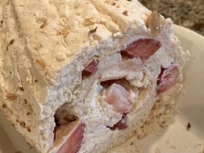A delicious meringue roulade with strawberries and cream.