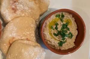 A plate of baba ganoush with homemade pita during a cooking vacation with The International Kitchen.