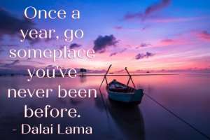 An inspirational Dalai Lama quote over a picture of a boat on water at sunrise.