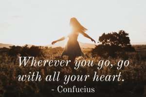 An inspirational quote with a woman dancing in a field.