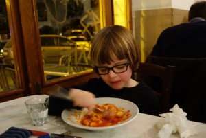 Introducing my son to the Roman tradition of gnocchi on Thursdays during a cooking vacation in Italy.