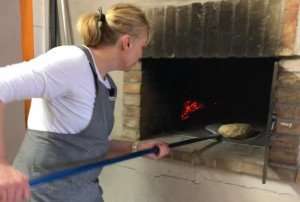 Baking bread in a wood-burning oven.
