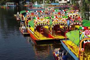 The colorful trajineras boats in the Xochimilco quarter during a Mexico City culinary tour.