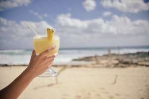 A delicious pina colada cocktail on the beach.