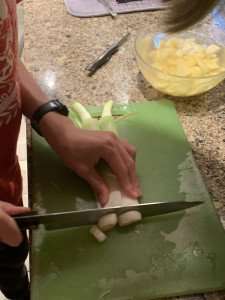 Chopping leeks during a cooking class.