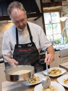 Enjoying time cooking with the chef at the French cooking school.