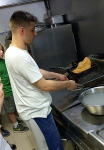 A Neapolitan pizzaiolo frying a pizza fritta.