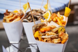 Fried seafood in cones on the street of Riomaggiore, Italy