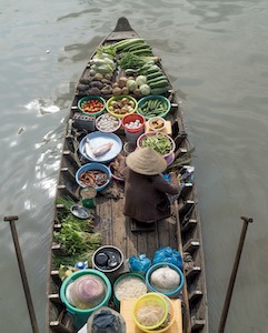 Vendor on a floating market in Vietnam.
