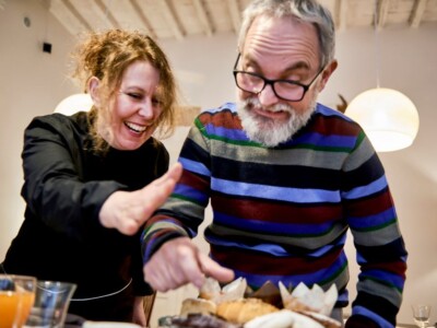 Chef Chiara and her brother laughing over food