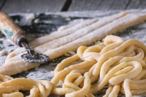 Preparing hand rolled pici pasta