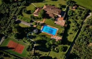 A view of the estate with villa, pool, tennis course, and olive groves.