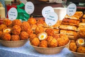 Scotch eggs are a delicious UK delicacy comprised of a hard boiled egg wrapped in sausage, coated in breadcrumbs, and deep fried.
